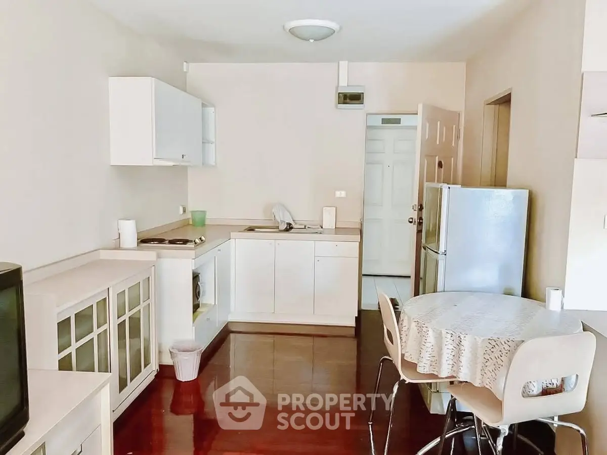Cozy kitchen with dining area and modern appliances in a bright apartment