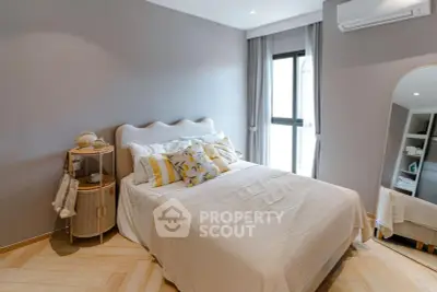 Cozy bedroom with stylish decor and natural light, featuring a comfortable bed and elegant furnishings.