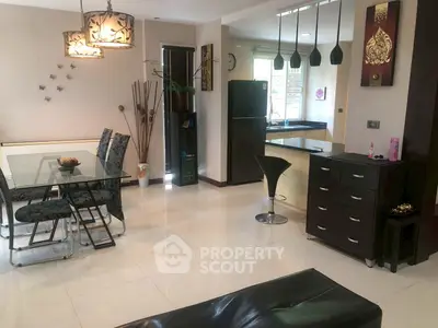 Modern open-plan living and dining area with stylish decor and natural light.