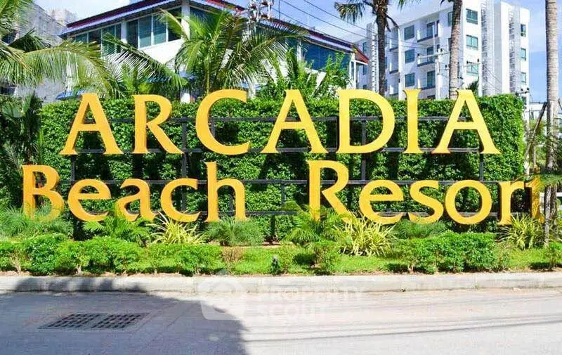 Arcadia Beach Resort entrance with lush greenery and modern architecture.