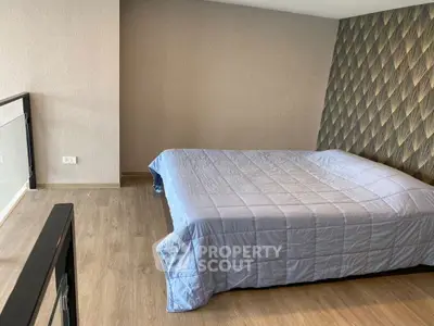 Modern bedroom with stylish wallpaper and cozy bedding in a contemporary apartment.