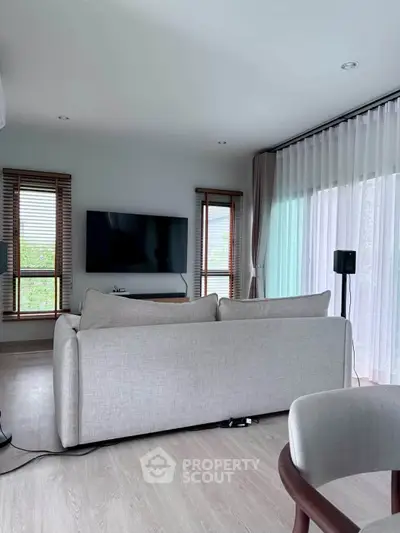 Modern living room with sleek design and large windows for natural light