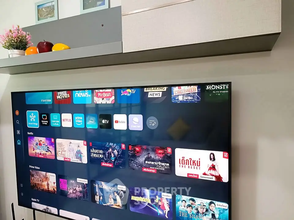 Modern living room with wall-mounted TV and sleek shelving unit.