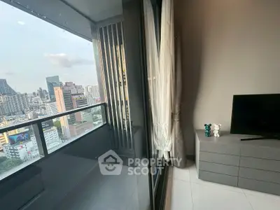 Modern high-rise apartment with stunning city view from balcony, sleek interior design and large windows.