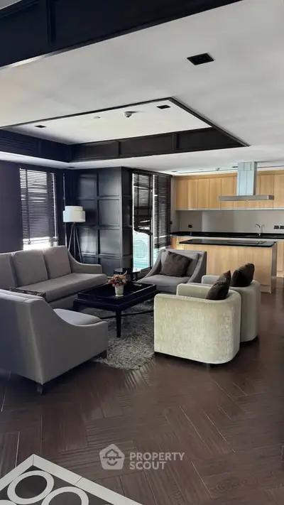 Luxurious modern living room with open kitchen, elegant furniture, and stylish decor.