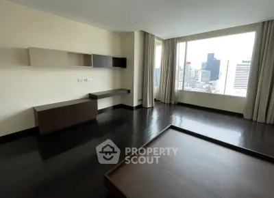 Spacious modern living room with city view and sleek dark flooring
