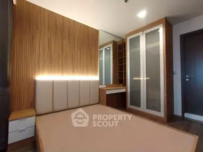 Modern bedroom with stylish wooden paneling and built-in wardrobe