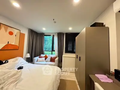 Cozy bedroom with modern decor and large window view