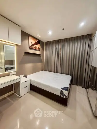 Modern bedroom with sleek design, featuring a comfortable bed, stylish vanity, and ample storage space.