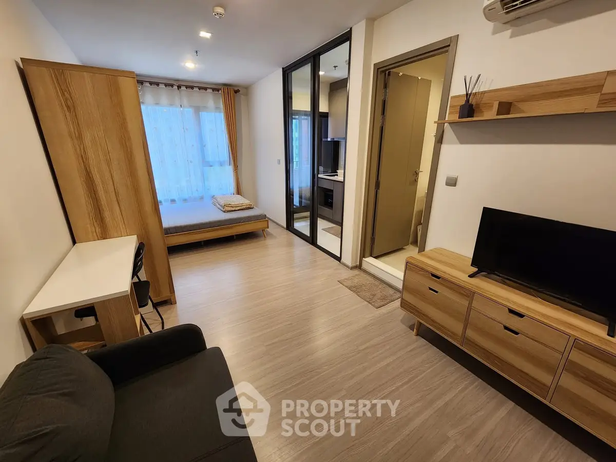 Modern studio apartment with open layout, featuring a cozy living area, bedroom, and stylish furnishings.