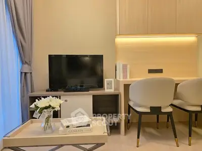 Modern living room with TV, elegant chairs, and stylish decor