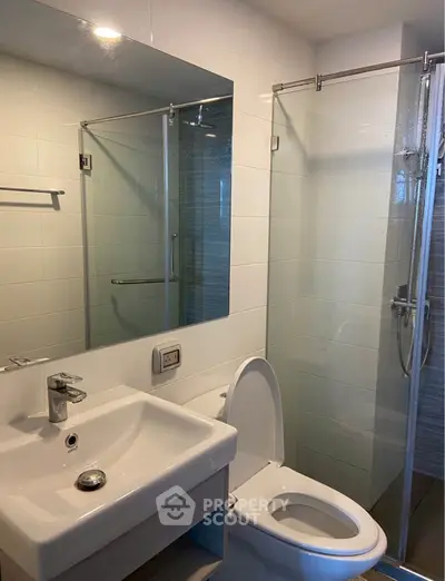 Modern bathroom with glass shower and sleek fixtures