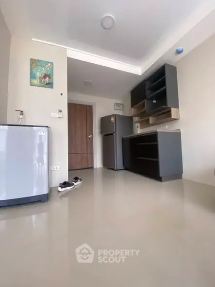 Modern kitchen with sleek cabinets and appliances in a stylish apartment.
