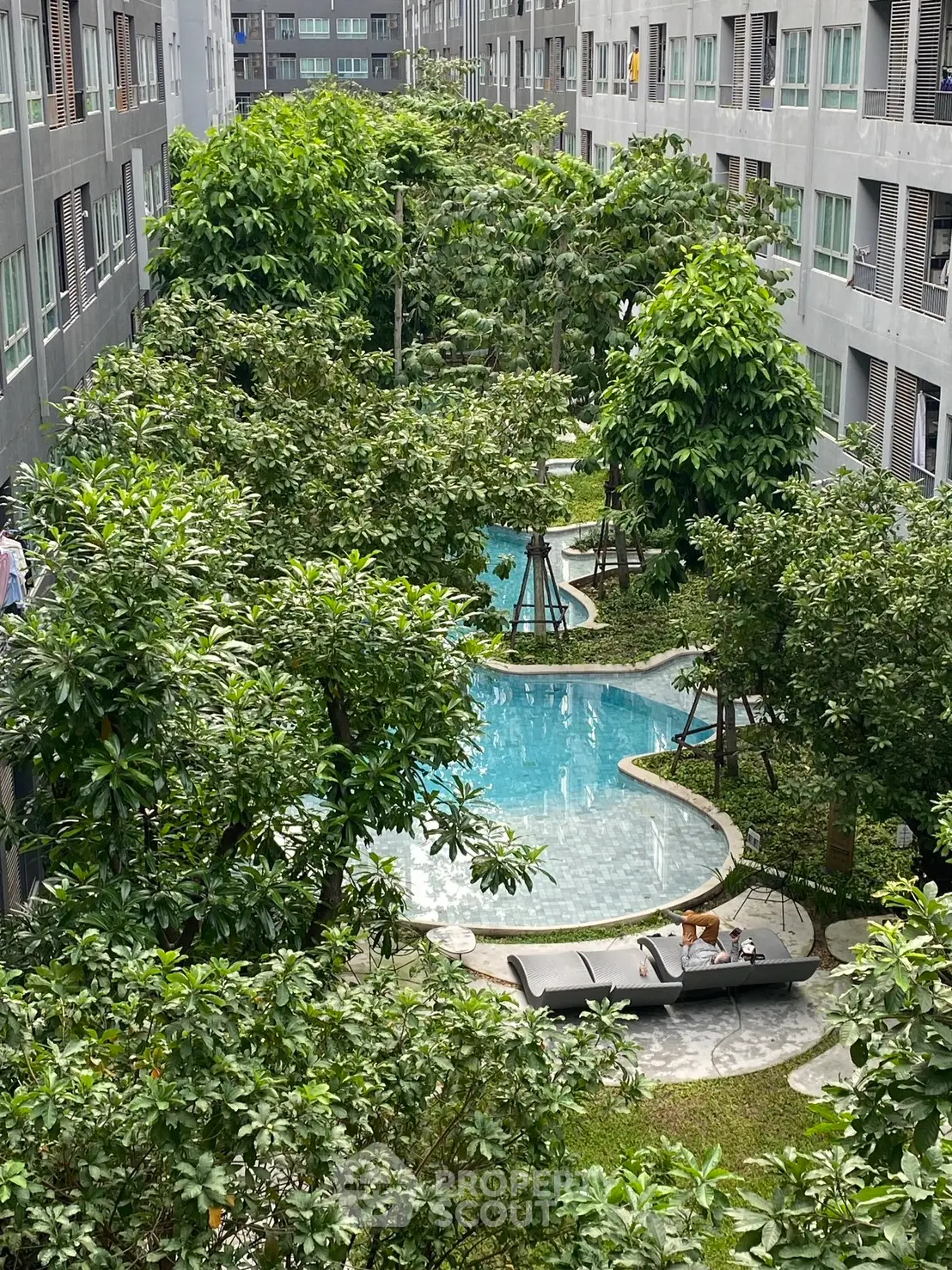 Luxurious residential complex with lush gardens and a serene pool area, perfect for relaxation and leisure.