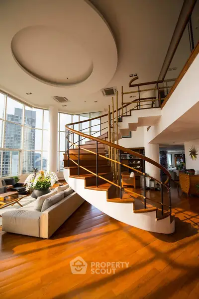 Luxurious living room with spiral staircase and panoramic city view