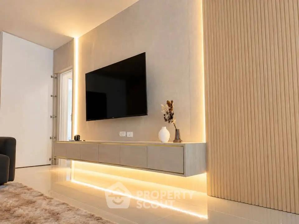 Modern living room with sleek TV setup and ambient lighting