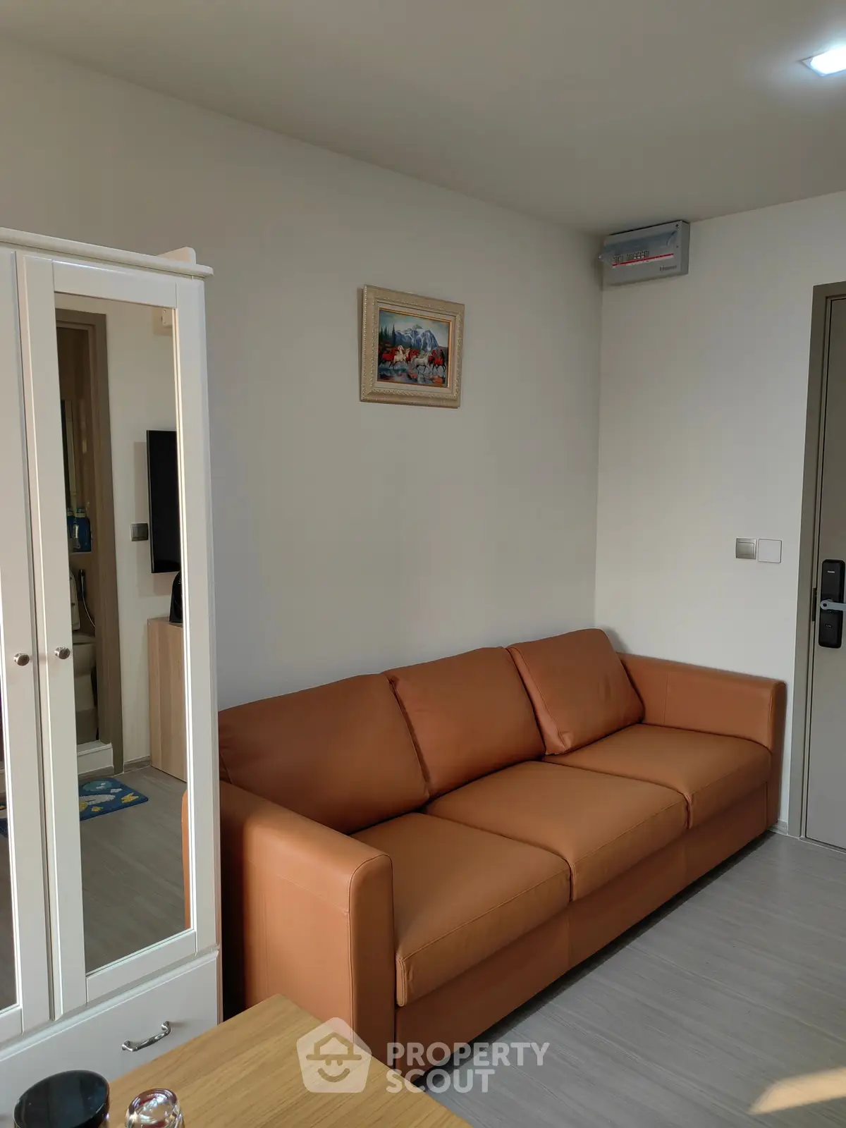 Modern living room with brown leather sofa and stylish decor