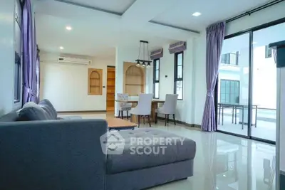 Spacious modern living room with elegant decor and large windows for natural light.