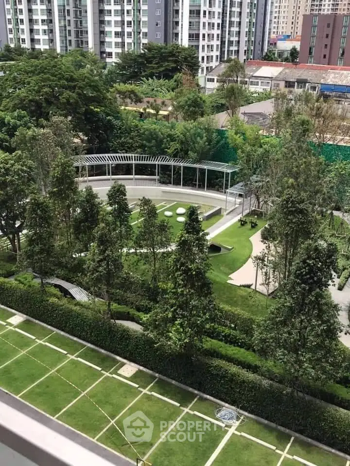 Lush green garden view from a high-rise apartment, perfect for relaxation and outdoor activities.