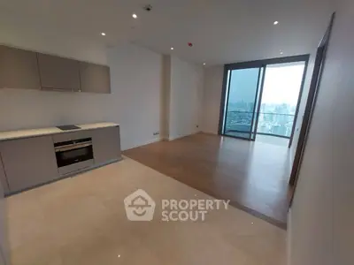 Spacious modern apartment with open kitchen and stunning city view from balcony.