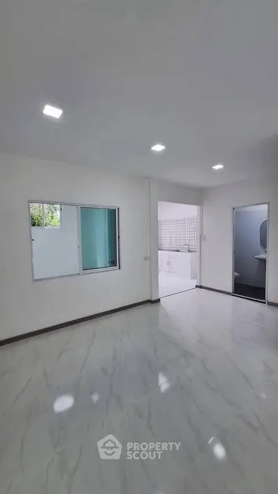 Spacious modern living area with marble flooring and bright lighting