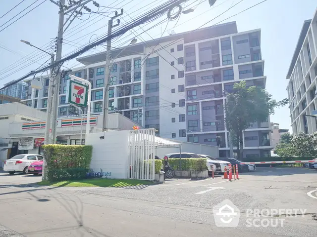 Modern apartment building with convenient 7-Eleven store nearby, ideal urban living location.