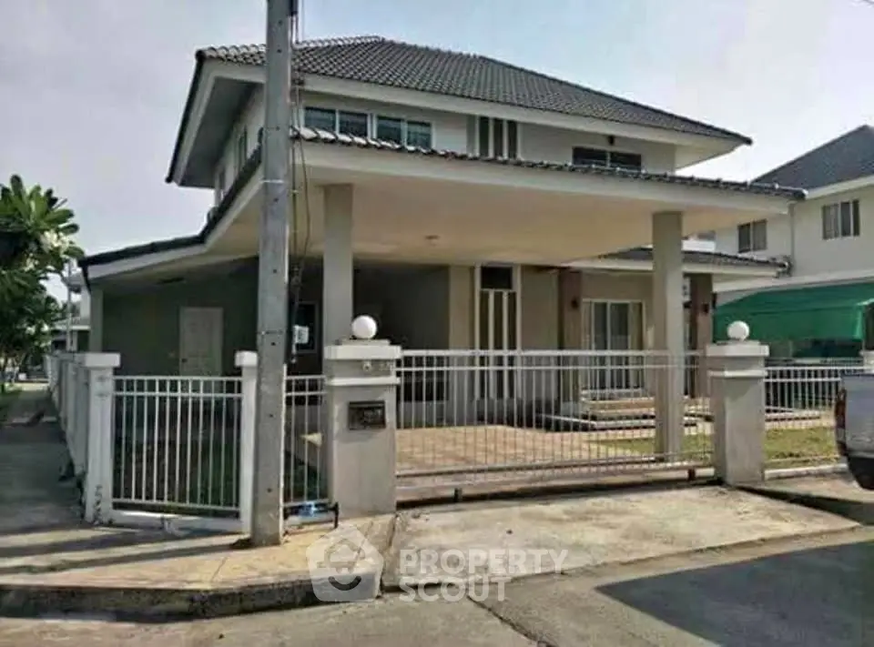 Charming two-story house with modern design and spacious front yard in a serene neighborhood.