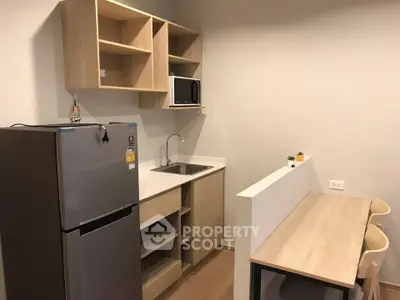 Modern compact kitchen with sleek appliances and minimalist design