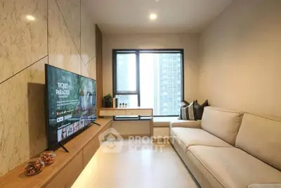 Modern living room with sleek design and large TV, perfect for entertainment.