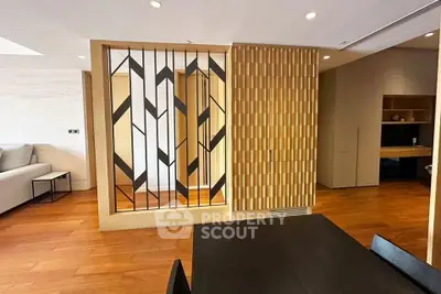Modern living room with stylish wooden partition and sleek furniture