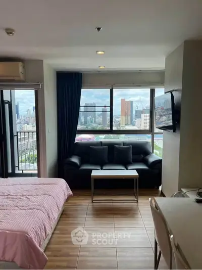 Modern studio apartment with city view and balcony access, featuring cozy living area and stylish decor.
