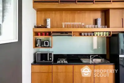 Modern kitchen with wooden cabinets, glass backsplash, and sleek appliances