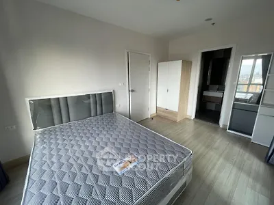 Spacious bedroom with modern design and ensuite bathroom in a stylish apartment.