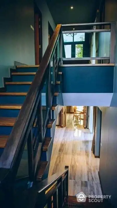 Elegant modern staircase with wooden railings and natural light