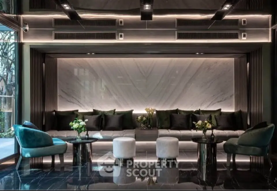 Luxurious modern lobby with elegant seating and marble accents in upscale building.