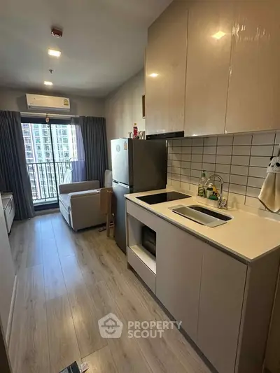 Modern kitchen with sleek cabinetry and open layout in a stylish apartment