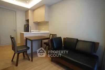 Modern apartment interior with cozy living area and compact kitchen