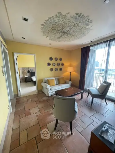 Charming living room with artistic ceiling design and cozy seating area, perfect for relaxation.