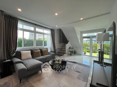 Spacious modern living room with large windows and stylish decor