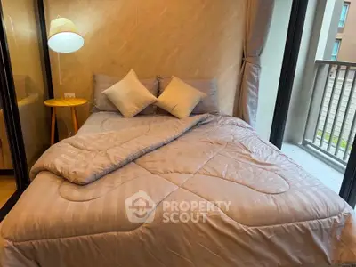 Cozy bedroom with modern decor and balcony access in a stylish apartment.