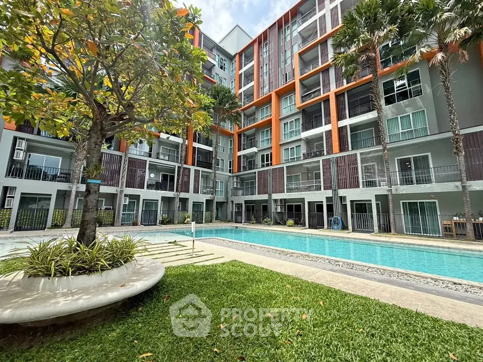 Modern apartment complex with pool and lush greenery, perfect for urban living.