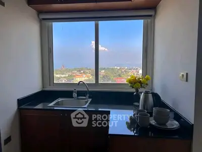 Charming kitchen with stunning city view, featuring sleek countertops and modern appliances.