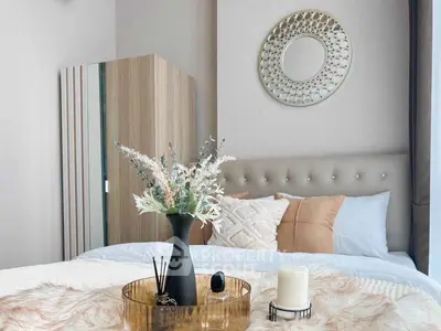 Elegant bedroom with stylish decor and plush bedding in modern apartment