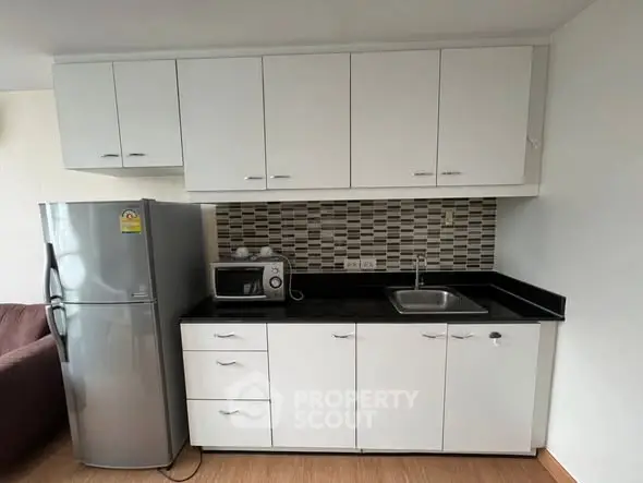 Modern kitchen with sleek cabinets and stainless steel fridge