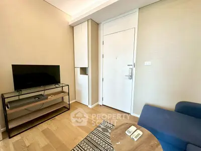 Modern living room with TV and stylish furniture in a cozy apartment.