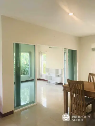 Spacious dining area with wooden furniture and large windows