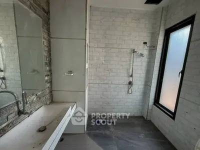 Modern bathroom with sleek design and large window for natural light.