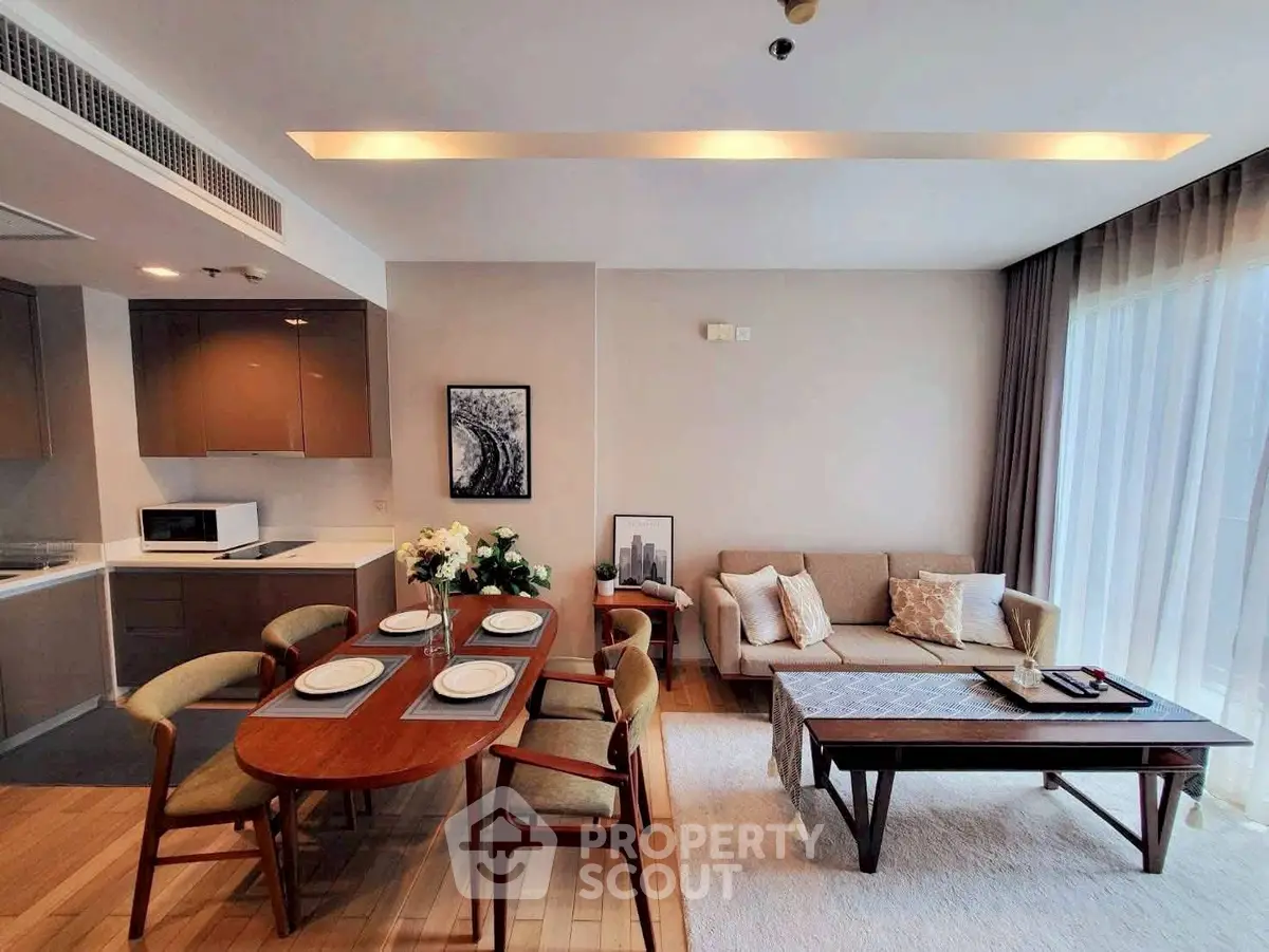 Modern open-plan living and dining area with elegant decor and natural light.