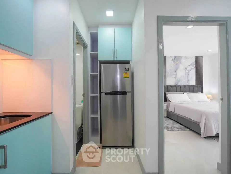 Modern apartment interior with sleek kitchen and cozy bedroom view