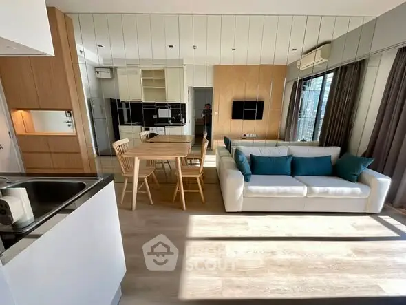 Modern open-plan living room with stylish decor and ample natural light